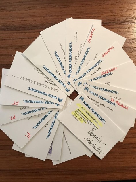 A fanned out circle of Kaiser Permanente business cards for healthcare professionals